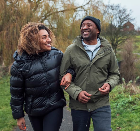 Woman and older gentleman walking down a path.